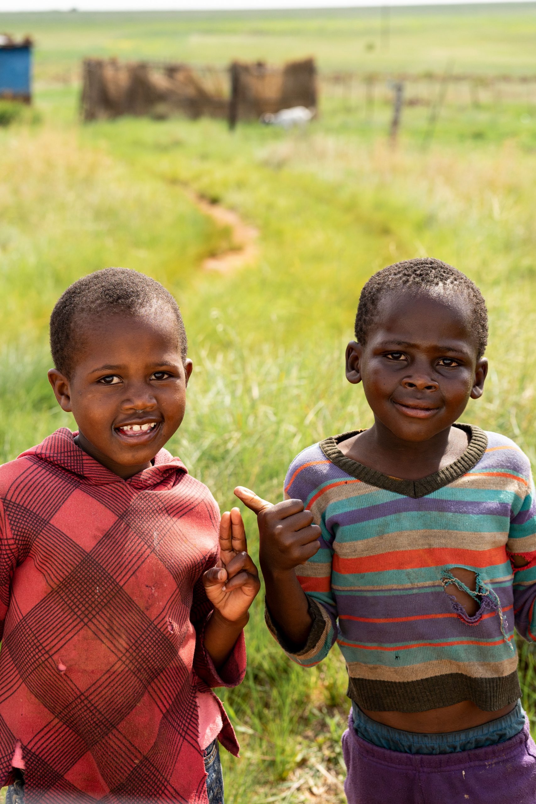 Two boys with colorful sweaters smiling 