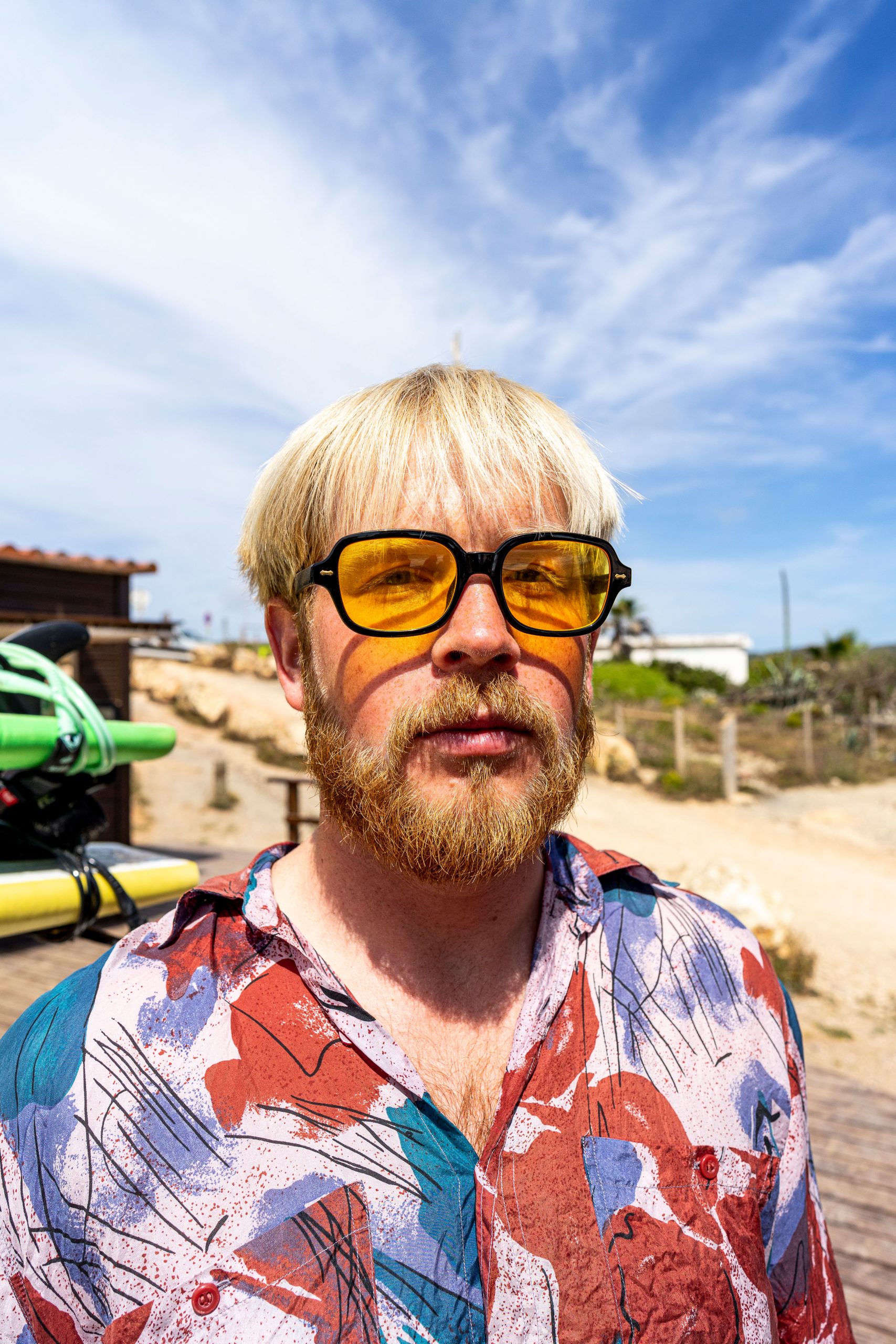 Blonde man with colorful outfit